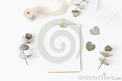 Feminine wedding desktop stationery mockup with blank greeting card, dry eucalyptus leaves, silk ribbon and golden Stock Photo