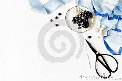 Feminine wedding or summer marine table composition. Porcelain plate with blackberry fruit, blueberries, oyster, blue Stock Photo