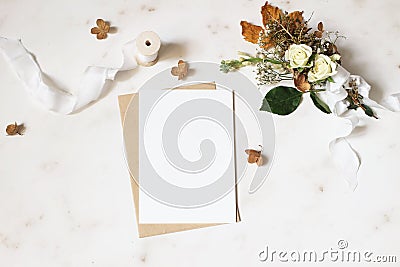 Feminine winter wedding, birthday stationery mock-up scene. Blank greeting card, envelope. Dry hydrangea, white roses Stock Photo
