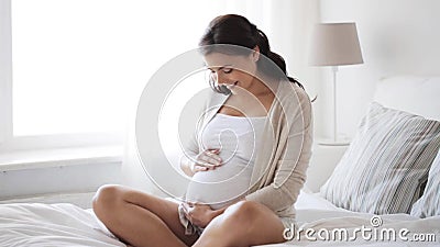 Femme enceinte heureuse touchant son ventre à la maison 12 clips vidéos Femme enceinte heureuse touchant son ventre à la maison 12 clips vidéos