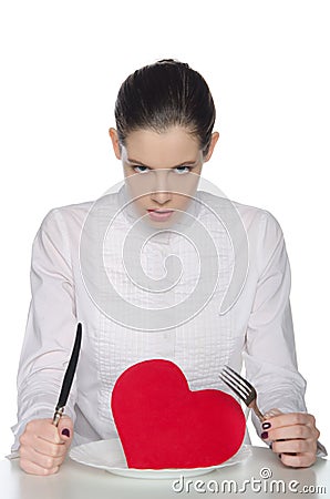 Femme fatale eats heart knife and fork Stock Photo