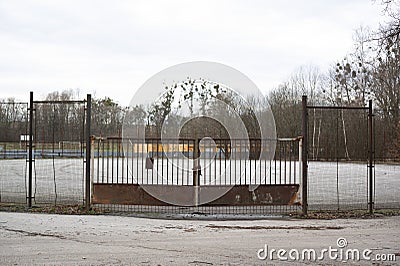 Fence and barrier made of metal, gate and door is closed by lock and chain Stock Photo