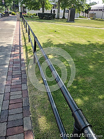 Fence down sidewalk Stock Photo