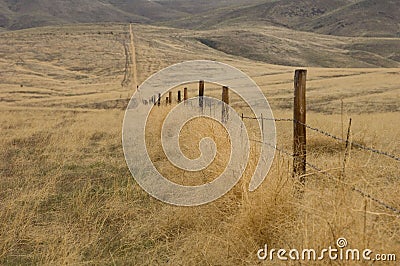 Fence line in the sage brush Stock Photo