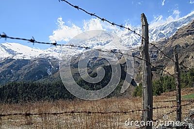 Fence made of barbed wire stopping people to enjoying beauty of nature Stock Photo