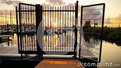 Fence of metal that is closed and confines or excludes. A locked-up closure that can feel like a prison. Stock Photo