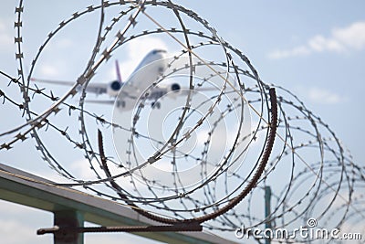 Fence with razor barbed wire protection against blue sky background. Dictatorship and tyranny concept Stock Photo