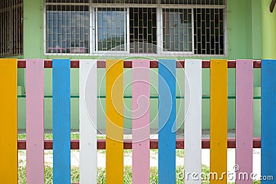 The fence of the school is in a colorful community. backgruond Stock Photo
