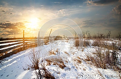 Fence in winter field Stock Photo