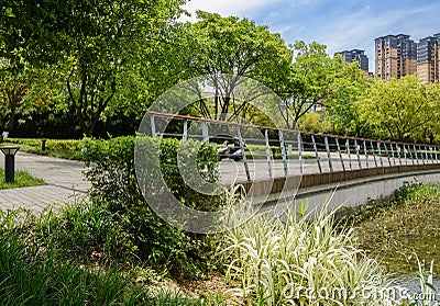 Fenced footpath at waterside in modern city at sunny summer noon Editorial Stock Photo