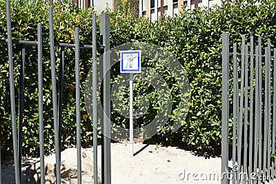 Fenced and hedged place with outdoor dog potty area or toilet and potty station with pea gravel Stock Photo