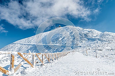 Fenced hiking path to Snezka mountain on a sunny day in winter, Giant mountains Krkonose, Czech republic Stock Photo