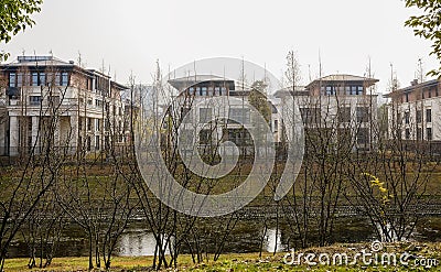 Fenced villas along rivulet in sunny winter afternoon Stock Photo