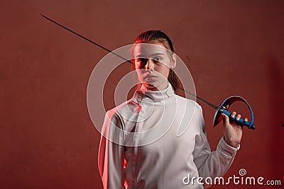 Fencer woman with fencing sword. Stock Photo