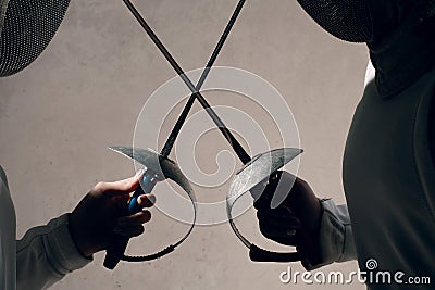 Fencer woman with fencing sword. Fencers duel concept. Stock Photo