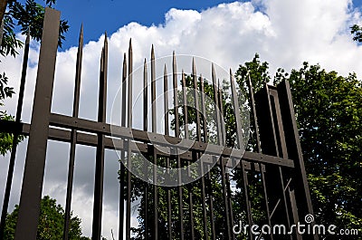 Fencing of building from forged bars with curved spikes. military guarded bases and an embassy with increased protection against o Stock Photo