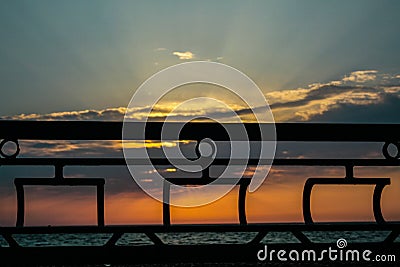 Fencing in form of ships with scarlet sails at sunset Stock Photo