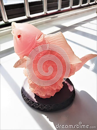 Fengshui Jade Red Gold Fish sculpture representing wealth and abundance Stock Photo