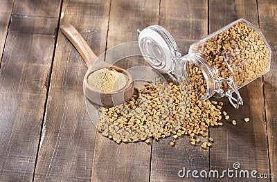 Organic fenugreek seeds powder - Trigonella foenum - graecum Stock Photo