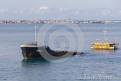 Close-up of Greek bulk carrier ship that was thrown by storm in shallow water near Genoese fortress in Feodosia. Editorial Stock Photo