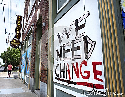 Ferguson, Missouri, USA, June 20, 2020 - We need change sign painted on boarded up business windows after police brutality riots Editorial Stock Photo