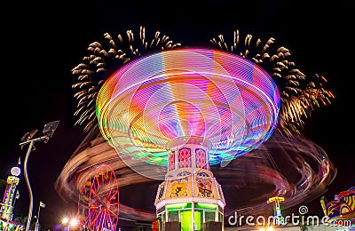 Feria juegos mecanicos light trail rides night long exposure fireworks Editorial Stock Photo