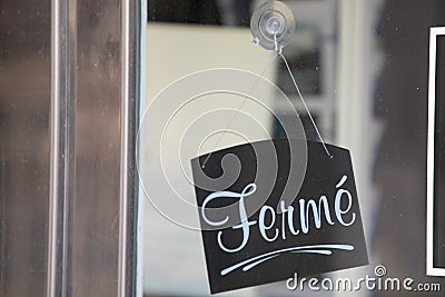 ferme in french means closed text entrance board windows door vintage shop sign close store Stock Photo