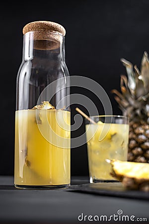 Fermented pineapple lemonade on a black background. Vertical frame Stock Photo