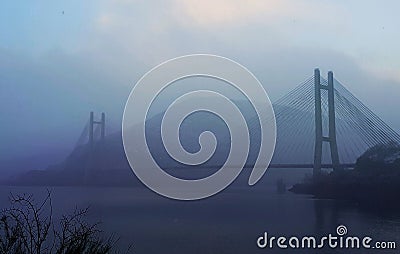 Cloudy bridge over a lake Stock Photo