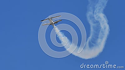 Small vintage biplane Christen Pitts S-2B Special with smoke in flight Editorial Stock Photo