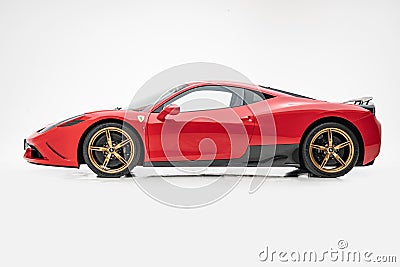 Ferrari 458 Speciale Red with golden wheels, studio, white background, side view Editorial Stock Photo