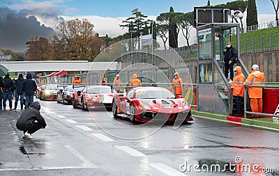 Ferrari supercar 488 gran turismo racing motorsport cars standing in circuit pit lane track on wet asphalt Editorial Stock Photo