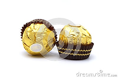 Ferrero Rocher is premium chocolate ball sweets filling with nuts and luxury delicious. Italian chocolate candies isolated on whit Editorial Stock Photo