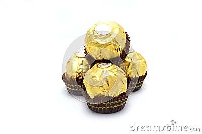 Ferrero Rocher is premium chocolate ball sweets filling with nuts and luxury delicious. Italian chocolate candies isolated on whit Editorial Stock Photo