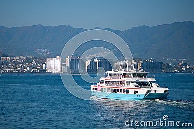 Ferries boat crossing the inland sea between Miyajimaguchi and Miyajima Editorial Stock Photo