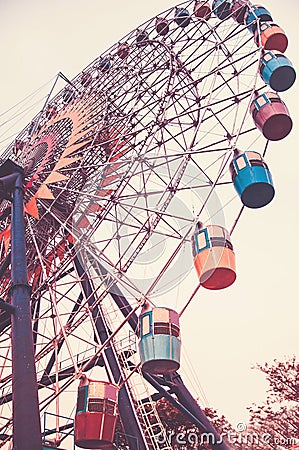 Big Ferris wheel. Bottom view. Toned vertical image in retro style. Stock Photo