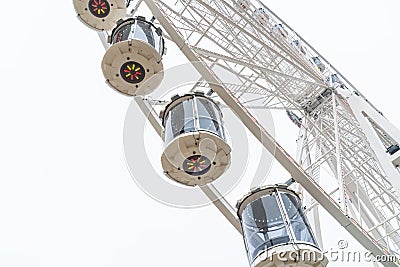 Ferris wheel close-up on gray sky background, traditional fairground attraction Stock Photo