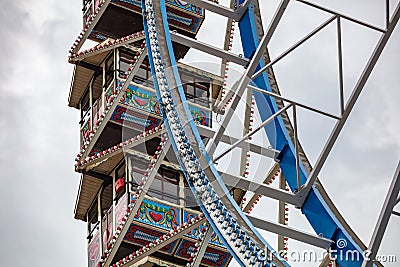 Ferris wheel closeup detail view on cloudy sky. Oktoberfest, Bavaria, Germany Editorial Stock Photo