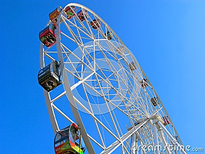 Ferris wheel, colorful cabins, clear blue sky Editorial Stock Photo