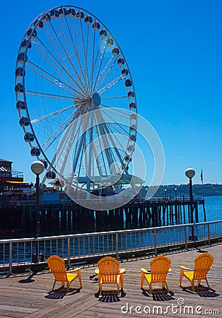 Big Wheel with Four Yellow Chairs Stock Photo