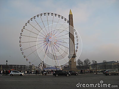 A ferris wheel next to the Luxor Obelisk, Paris Editorial Stock Photo