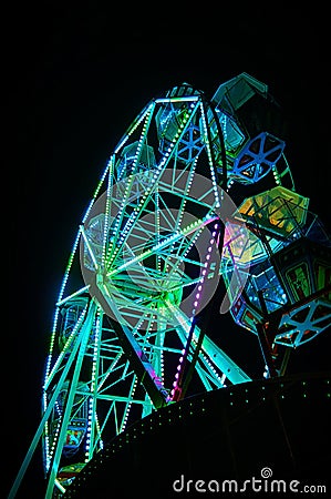 Ferris wheel at night with green light Stock Photo