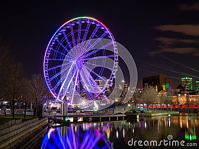 The ferris wheel of the old port of Montreal with the colors of the rainbow concerning the covid-19 Editorial Stock Photo