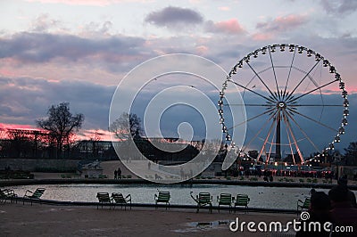 Ferris wheel in Paris. Roue de Paris. View from The Tuileries Garden. Sunset in Le jardin des Tuileries Stock Photo