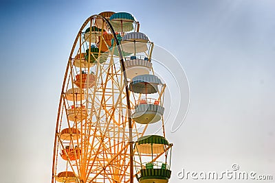 Ferris wheel-yellow with multi-colored booths Stock Photo