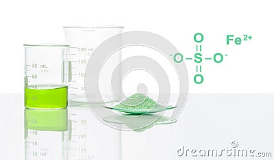 Ferrous Sulfate in chemical watch glass with chemical structure place next to Iron (II) sulfate liquid in Beaker. Stock Photo