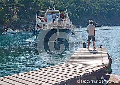 Ferry arrival and waiting tourists Editorial Stock Photo