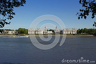 Ferry boat passing the old Royal Naval College in the Thames at Greenwich, England Editorial Stock Photo