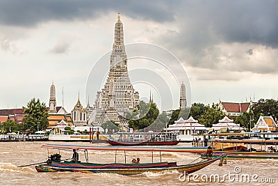 Ferry crossing Chao Phraya River in front of Wat Arun temple in Bangkok Editorial Stock Photo