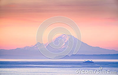 A ferry crossing the Puget Sound at sunrise with Mount Rainier i Stock Photo